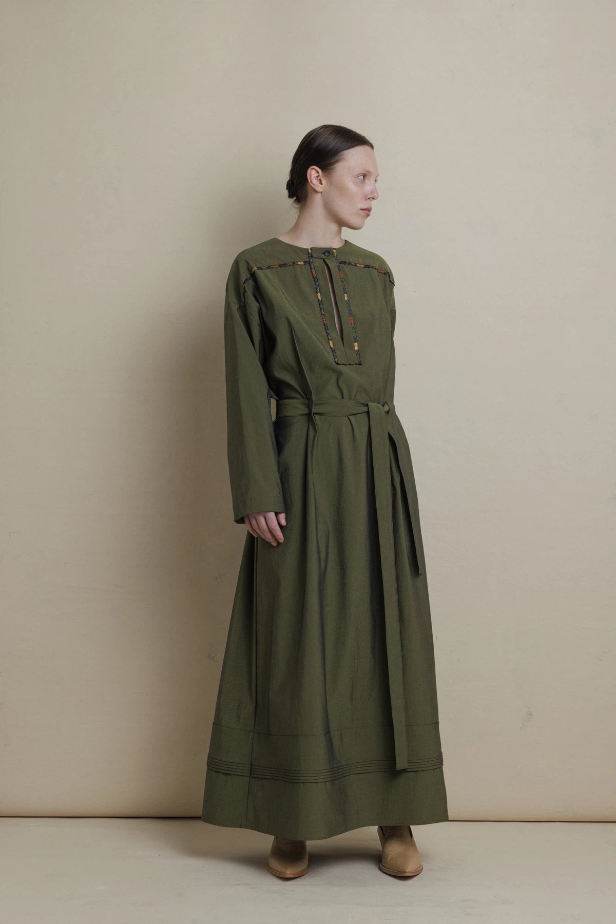 Green dress with multicolored finishing