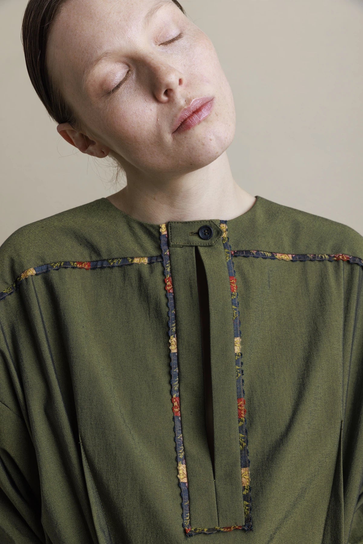 Green dress with multicolored finishing